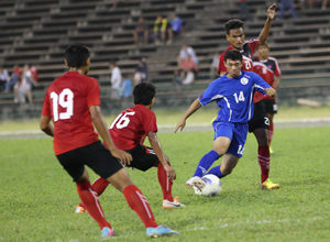 The Matao's Dylan Naputi breaks through the last line of Cambodia defenders during a FIFA international friendly match at the Olympic Stadium in Phnom Penh Tuesday. Guam shut out Cambodia 2-0 in the contest.