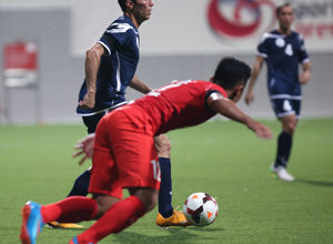 Guam's Alex Lee gets ahead of Singapore defender Sahil Suhaimi to the goal during a FIFA international friendly match at the Jalan Besar Stadium in Singapore Tuesday. Both teams battled to a 2-2 draw.