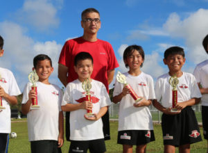 Samurai team members pose with their championship trophies of the U10 division of the 4th Guam Football Association 3v3 Grassroots Tournament held Saturday at the GFA National Training Center. From left to right are: Kosuke Ishii, Robert Moulthrop, Aidan Jones, coach Carl Jones, Kanata Kishi, Nicolas Chargualaf, and Rintaro Nishioka. Samurai defeated the Bulldogs in the final.