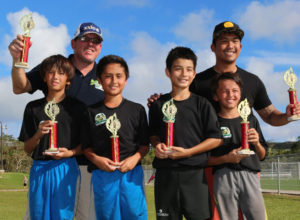 Shenron FC team members pose with their championship trophies of the U12 division of the 4th Guam Football Association 3v3 Grassroots Tournament held Saturday at the GFA National Training Center. From left to right are: Alexander Stenson, coach Steven Stenson, Andrew Kilgore, Taiga Simon, coach Ross Awa, and Andrew Stenson. Shenron FC defeated the Islanders Betde in the final.