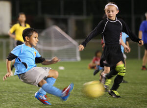 The Sidekick SC Silver's Erwin Manibusan, Jr. takes a shot ahead of the Wings FC U8 second team's Catherine Probola during the U8 championship match of the Guam Football Association U8 & U10 Youth Tournament at the GFA National Training Center Saturday. The Wings team went on to win the U8 championship.