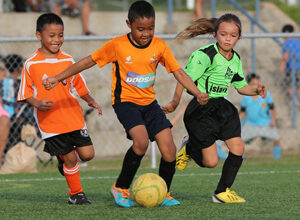 The Orange Crushers and the ASC Trust Islanders play in an early round match of the Guam Football Association U8 & U10 Youth Tournament at the GFA National Training Center Saturday.
