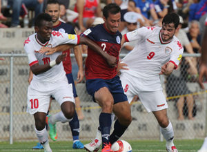 Guam's Alexander Lee stays in control of the ball as Oman's Qasim Said (10) and Abdul Aziz Al-Maqbali (9) try to strip the ball away from him during a match of the 2018 FIFA World Cup Russia and AFC Asian Cup UAE 2019 Preliminary Joint Qualification Round 2 at the Guam Football Association National Training Center Sept. 8. The teams battled to a 0-0 draw.