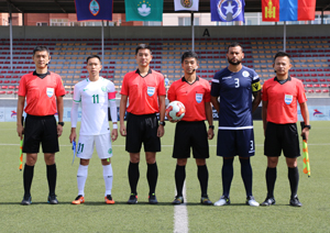 Guam's Shawn Nicklaw, in navy blue, poses in the captains photo with referees ahead of the Matao's match against Macau during the EAFF E-1 Football Championship Round 1 in Ulaanbaatar, Mongolia last week in this file photo. Guam finished 1-1-1 in the tournament and now look forward to preparing for the upcoming AFC Asian Cup and FIFA World Cup qualifiers. Photo courtesy of the Mongolian Football Federation (MFF).