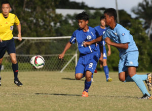 Northern Mariana Islands' Lolobeyong Benito tries to keep back Guam's Jonathan Sevilla from the ball in a Day 2 match of the EAFF East Asian U13 2015 Festival held at LeoPalace Resort Guam Monday.