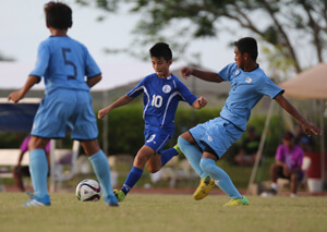 Guam's Anthony Taiga Simon prepares to take a shot ahead of Northern Mariana Islands defenders Ian Maniago (5) and Kirt Andon (3) in a Day 2 match of the EAFF East Asian U13 2015 Festival held at LeoPalace Resort Guam Monday.