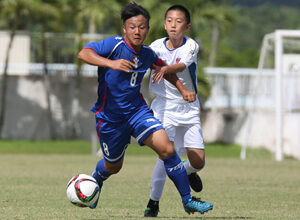 Chinese Taipei team captain Yang Sheng-Kai attempts to break free from the defense of DPR Korea Select's Kang Ji Hun to sprint to the goal in a Day 2 match of the EAFF East Asian U13 2015 Festival held at LeoPalace Resort Guam Monday.