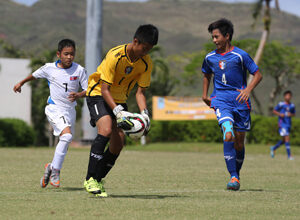 Chinese Taipei's second-half goalkeeper, Lin Jyun-Hua picks up the ball to prevent any shot attempt from DPR Korea Select's Jong Konsa in a Day 2 match of the EAFF East Asian U13 2015 Festival held at LeoPalace Resort Guam Monday.