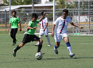 The ASC Trust Islanders' Javian Cruz prepares to strike the ball against visiting team Don Bosco of the Philippines in an opening day U14 division match of the Youth Invitational Gobblefest soccer tournament at the Guam Football Association National Training Center Friday. The Islanders won 5-1.