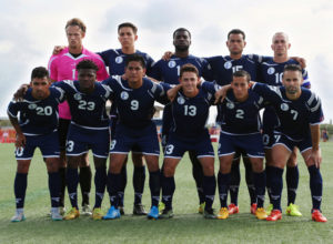 Guam's starting eleven players pose for a photo before the team's opening match of its 2018 FIFA World Cup Qualifier bid at the Guam Football Association National Training Center. First row from left to right are A.J. DeLaGarza, Shane Malcolm, Ian Mariano, Ryan Guy, Alexander Lee, and John Matkin. Back row from left to right are Doug Herrick, Mason Grimes, Brandon McDonald, Shawn Nicklaw, and captain Jason Cunliffe. Guam defeated Turkmenistan 1-0.