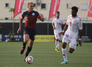 Guam captain Jason Cunliffe leads a run down the right side ahead of Oman's Ahmed Mubarak during a match of the 2018 FIFA World Cup Russia and AFC Asian Cup UAE 2019 Preliminary Joint Qualification Round 2 at the Guam Football Association National Training Center Sept. 8. The teams battled to a 0-0 draw.