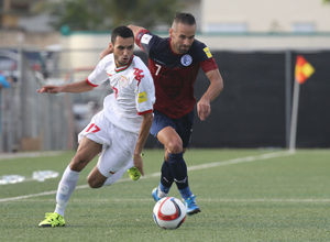 Guam's John Matkin and Oman's Ali Sulaiman Al Busaidi get into a foot race to the ball during a match of the 2018 FIFA World Cup Russia and AFC Asian Cup UAE 2019 Preliminary Joint Qualification Round 2 at the Guam Football Association National Training Center Sept. 8. The teams battled to a 0-0 draw.