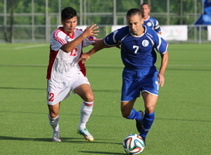 Guam's John Matkin keeps back Mongolia's Altankhuyang Murun as he carries the ball up the left flank during a Day 2 match of the EAFF East Asian Cup Round 1 tournament Wednesday at the Guam Football Association National Training Center. Guam blanked Mongolia 2-0.