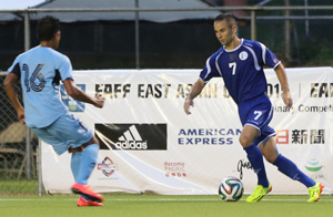 Guam's John Matkin (No. 7) looks to get around the defense of the Northern Mariana Islands' Ruselle Zapanta during a match of the EAFF East Asian Cup Round 1 Friday at the Guam Football Association National Training Center. Guam blanked NMI 5-0 to advance to the tournament semifinal round for the third-straight time.