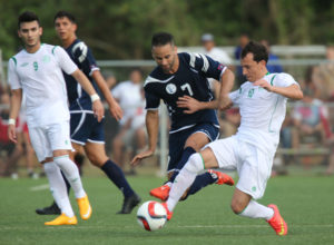 Guam's John Matkin swoops in to try to take possession of the ball from Turkmenistan's Abylov Guvanch during Guam's first-ever FIFA World Cup Qualifier match held in Guam Thursday afternoon at the Guam Football Association National Training Center. Guam defeated Turkmenistan 1-0.