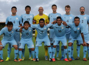 The starting eleven players from the Northern Mariana Islands pose for a group photo before the team's match against Macau on Day 2 of the EAFF East Asian Cup Round 1 tournament at the Guam Football Association National Training Center.