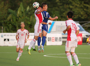 Guam's Ryan Guy leaps to flick back a header toward the goal over Mongolia's Tserenjav Enkhjargal during a Day 2 match of the EAFF East Asian Cup Round 1 tournament Wednesday at the Guam Football Association National Training Center. Guam blanked Mongolia 2-0.