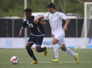 Guam's Shane Malcolm attempts to get past the defense of Turkmenistan's Soyunov Shohrat during Guam's first-ever FIFA World Cup Qualifier match held in Guam Thursday afternoon at the Guam Football Association National Training Center. Guam defeated Turkmenistan 1-0.